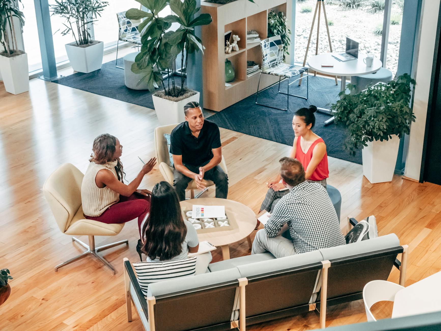 pexels-photo-7688173-7688173 A diverse group of professionals engage in a collaborative team meeting in a stylish office environment.